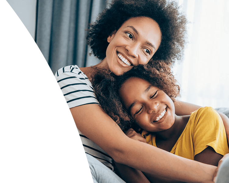 Mom hugging daughter.