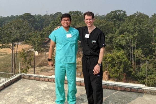 Ascension Via Christi International Family Medicine Residency fellows Joseph Sumhlei, MD, and Cody Rogers, MD, stand on top of Christian Memorial Hospital in Bangladesh.