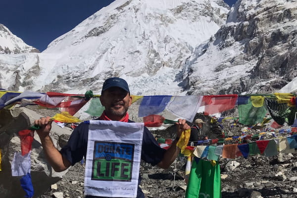 Respiratory Therapist Allan Thomas hung a prayer flag at Mount Everest honoring Kim Harter’s son, Sam, and organ donors