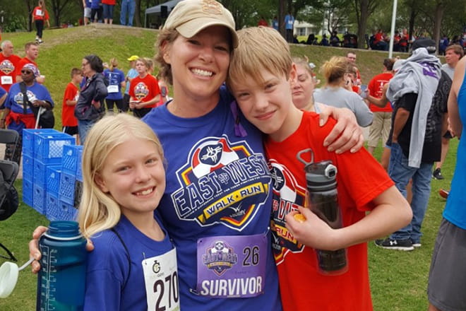 Amanda Hudson, breast cancer patient at Ascension Via Christi Cancer Center Wellness Program, pictured with her children during a survivor run. 