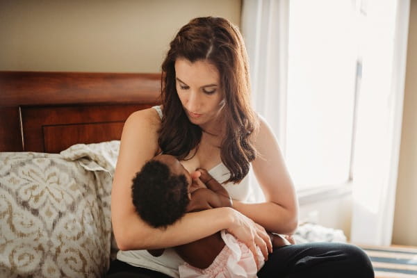 Jayme Thiessen breastfeeding new newborn, Maliyah. 
