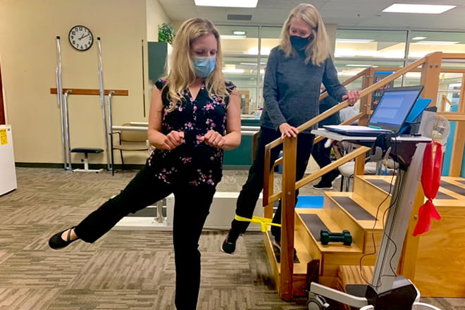 Ascension Via Christi physical therapist Melissa Warders instructs Sue Smith on a rehabilitation exercise. 