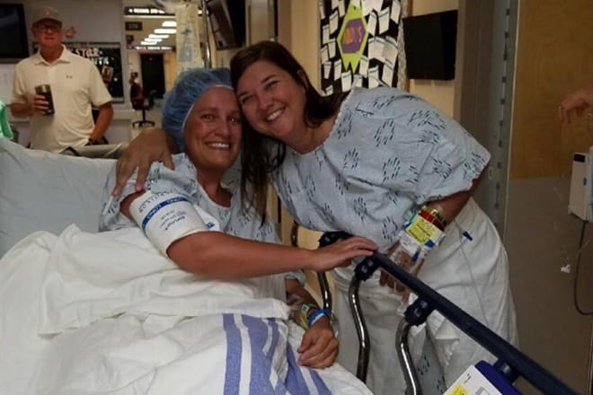 Susan Cox, living kidney donor, and Carrie Schlehuber, kidney recipient,  pose for a photo before Carrie goes into surgery to receive her kidney transplant.
