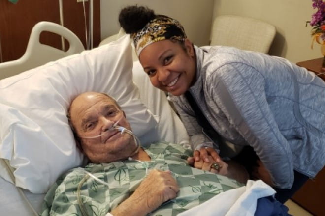 Vern Moss smiles with his patient care tech Kelsey White.