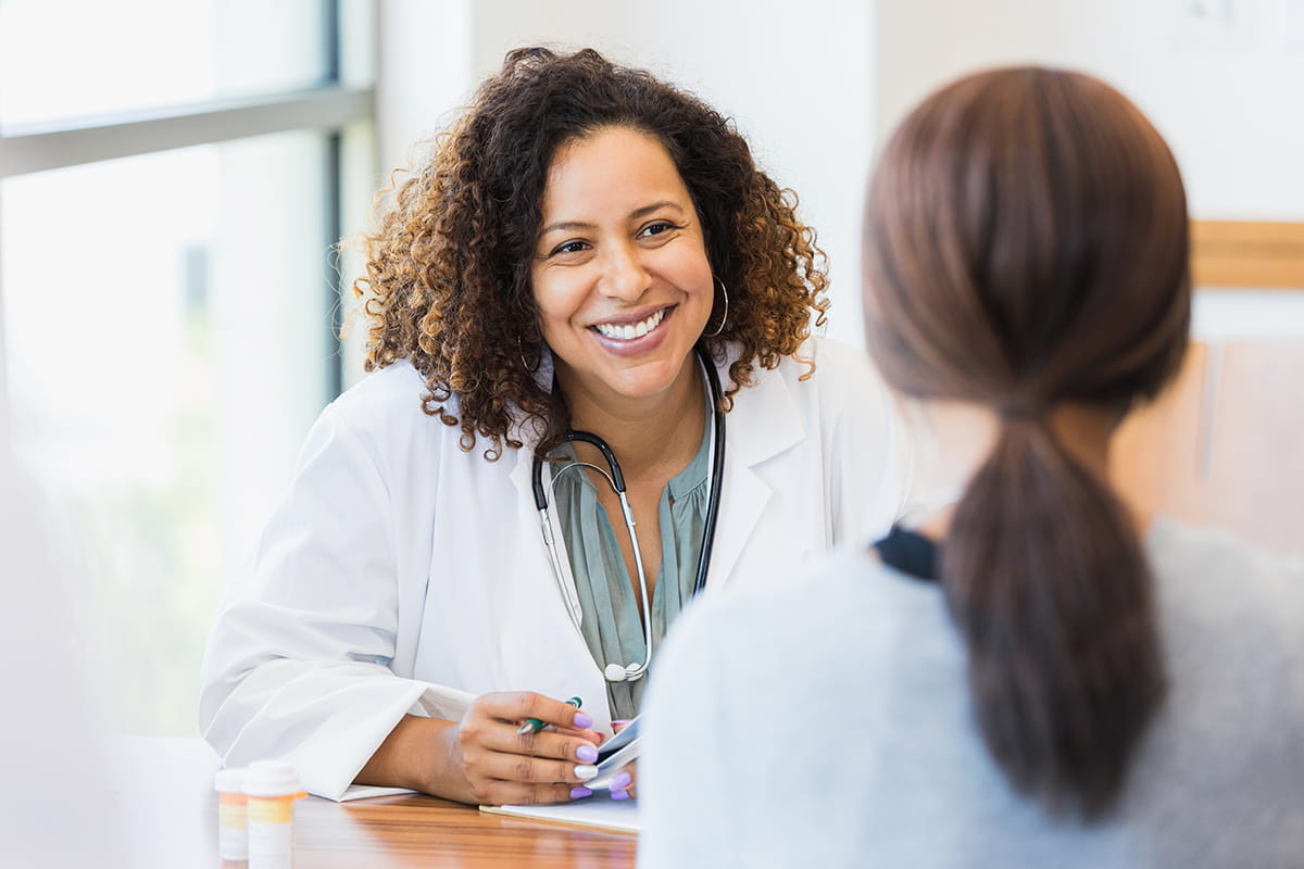 A female doctor talking with a female patient.