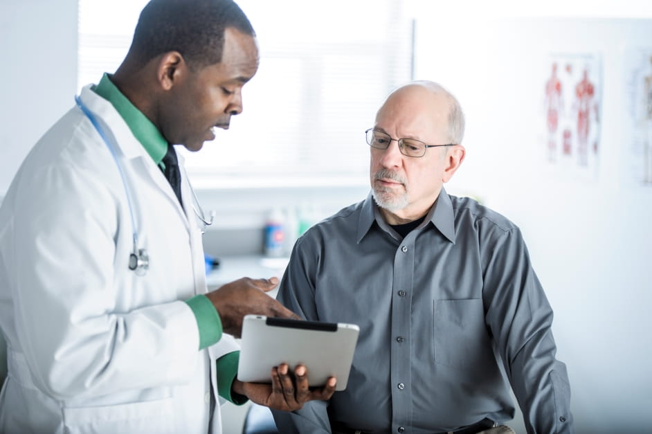 male doctor showing test results to a male patient