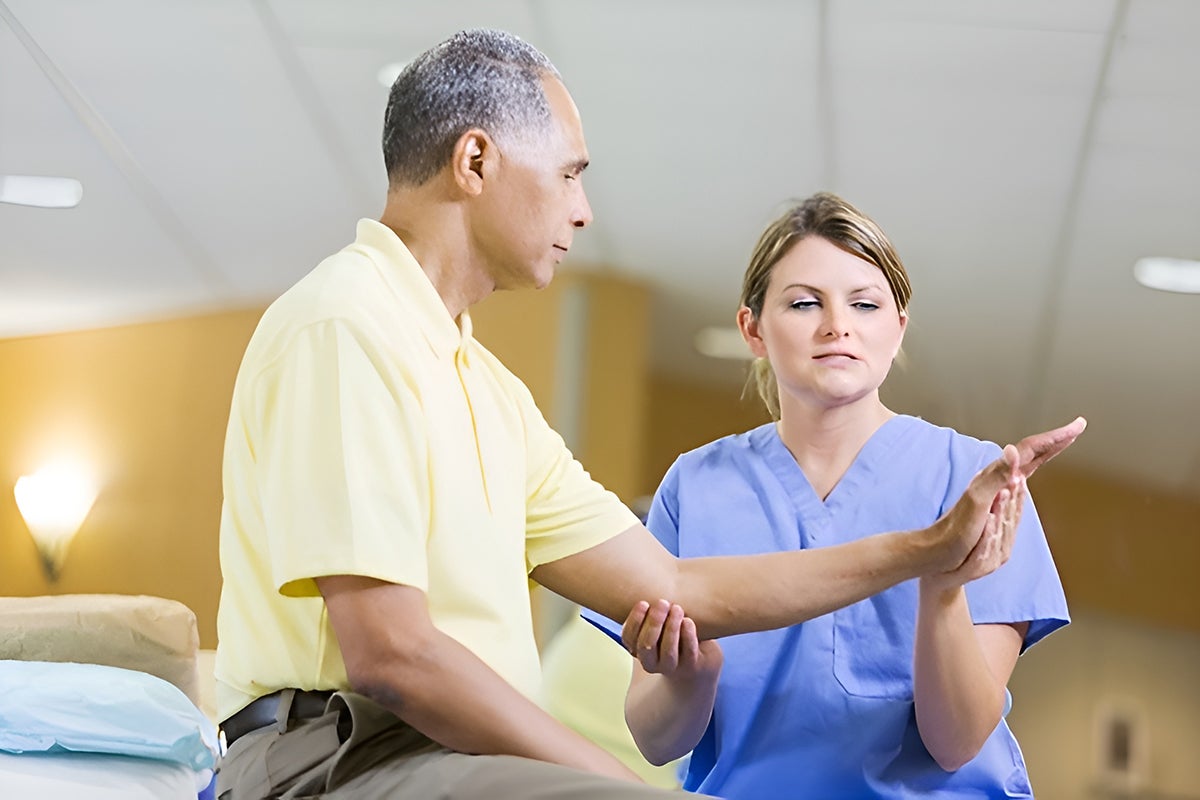 A patient receiving physical therapy care to help with his arm strength.