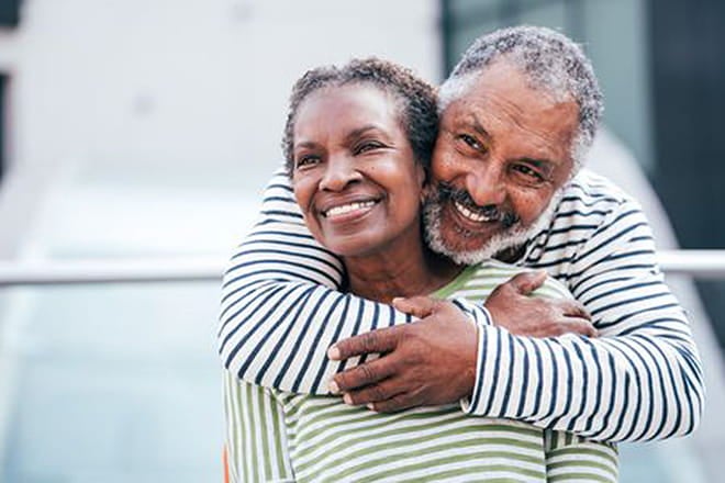 Smiling husband hugging his wife