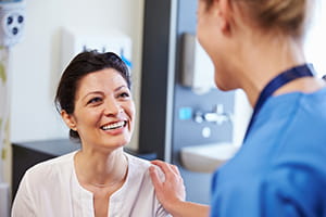Woman speaking with a nurse.