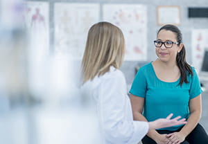 Doctor talking to a female patient.