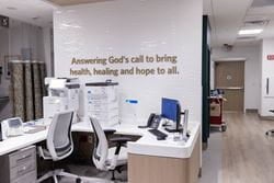 Emergency care nurses station with workstations and medical equipment at Ascension St. Vincent’s Southside.