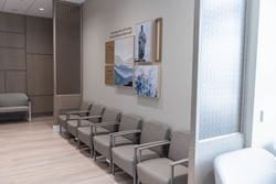 Patient waiting area with chairs, artwork and privacy screens at Ascension St. Vincent’s Southside.