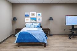 Home-style bedroom used for occupational therapy, allowing patients to safely practice transfers, mobility, and daily living activities before returning home.