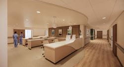 Ascension Sacred Heart - Inpatient Rehabilitation Facility nursing station with workstations and care team members in a patient care corridor.