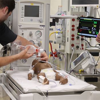 A nurse tends to a baby in the hospital NICU