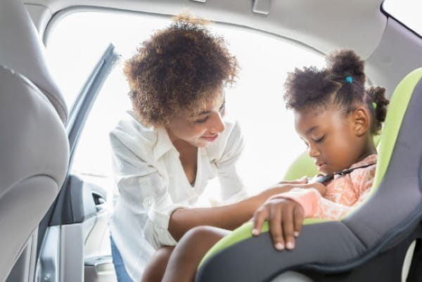 Mother and daughter buckling in the car seat; safety education from Peyton Manning Children’s Hospital, Indianapolis, IN