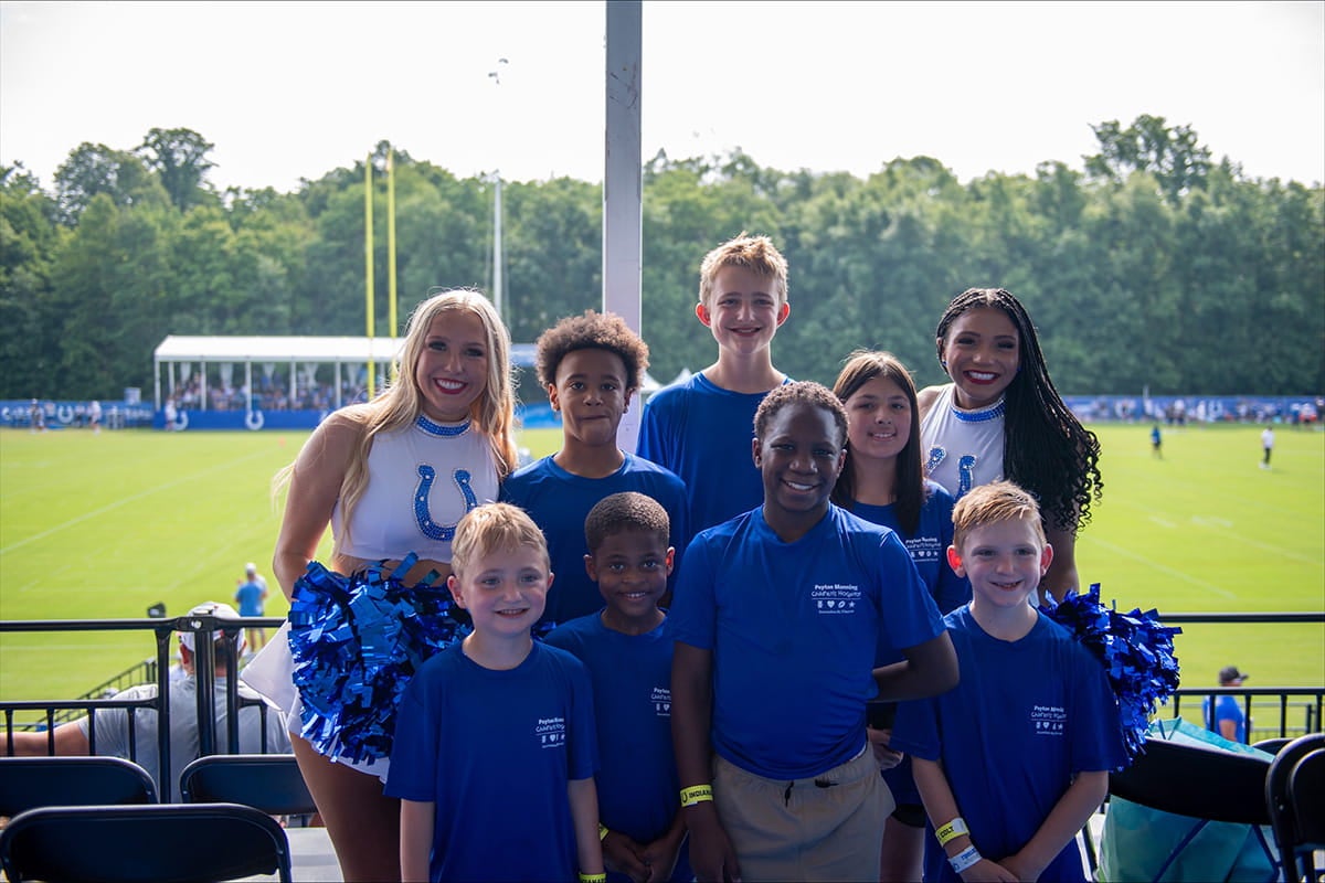 Children from Peyton Manning Children’s Hospital pose with Indianapolis Colts cheerleaders.