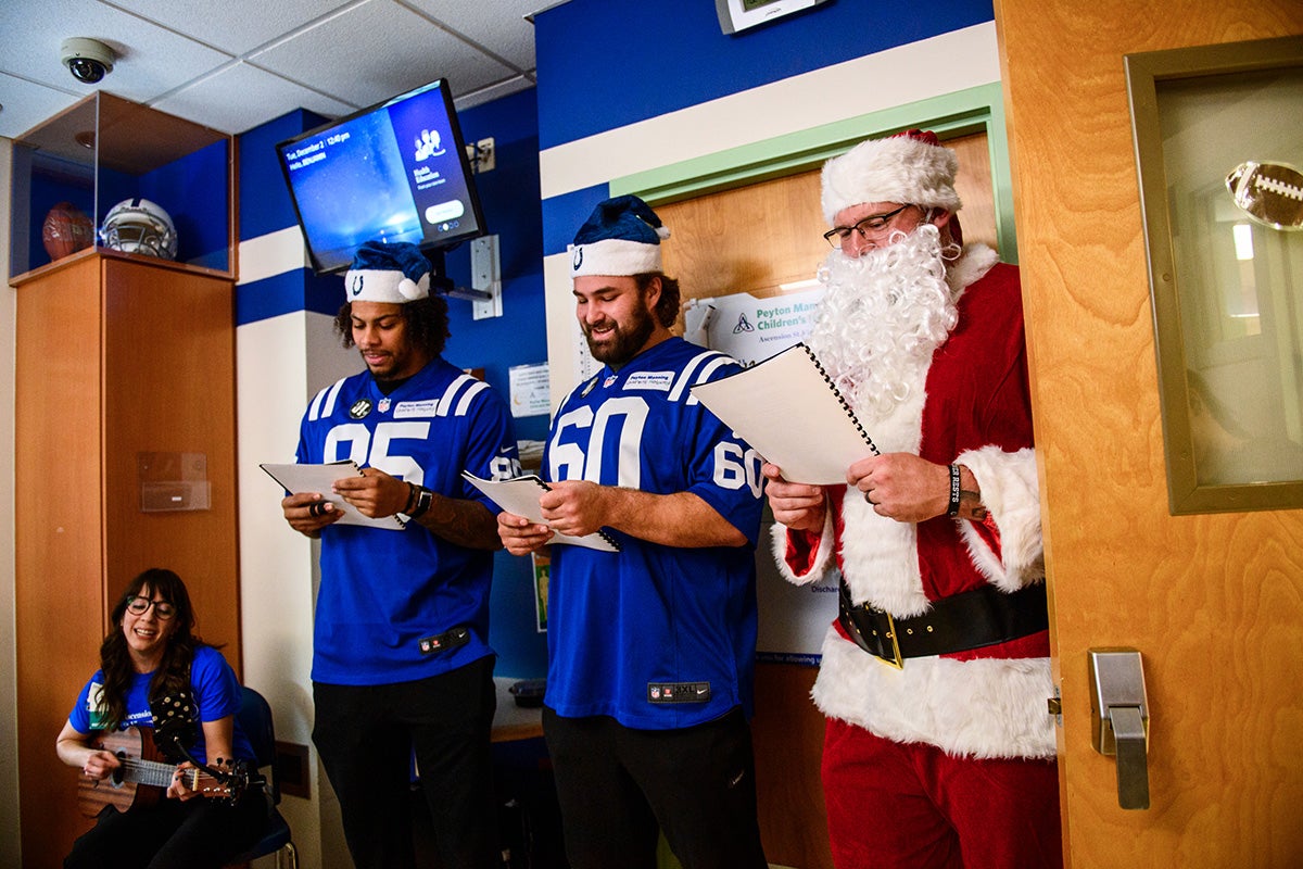 Colts players and Santa visit a patient room at Peyton Manning Children’s Hospital