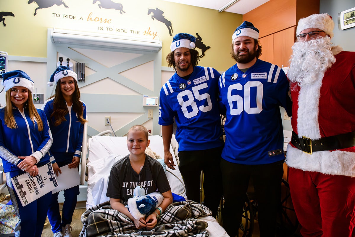 Colts players and Santa visit a pediatric patient in a hospital room at Ascension St. Vincent