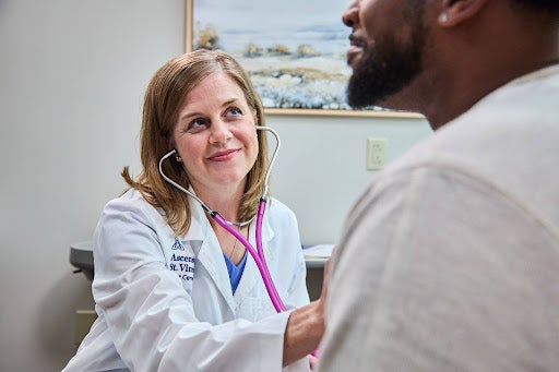 provider with stethoscope treating patient.