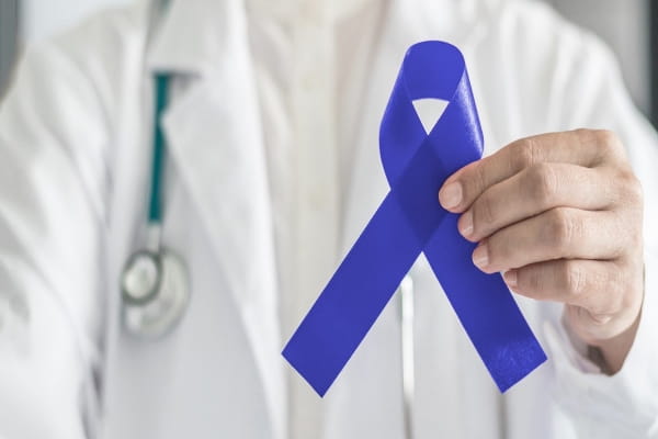 doctor holding a blue colorectal cancer awareness ribbon