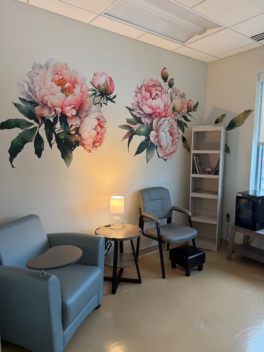Private “Chill Zone” treatment room at Ascension Saint Agnes featuring comfortable chairs, soft lighting, and a calming floral wall mural, designed to support patients undergoing scalp cooling therapy to help reduce chemotherapy-related hair loss.