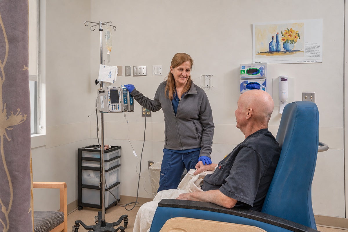 Man getting care from nurse at Ascension Saint Agnes Hospital Cancer Institute.