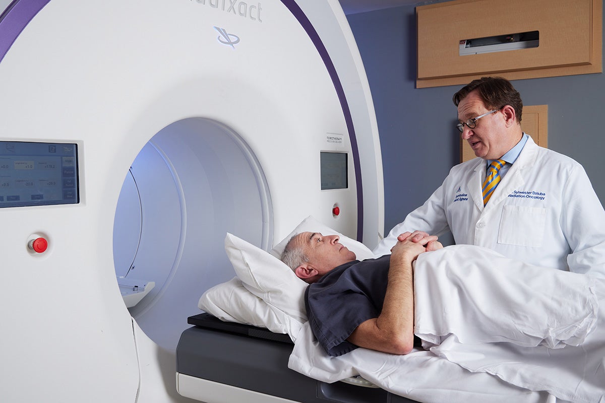 Man getting care with doctor during treatment at Ascension Saint Agnes Hospital Cancer Institute.