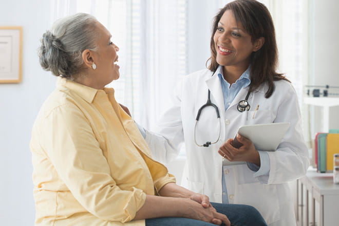 Female patient discusses her neurorehabilitation treatment options with her doctor. 