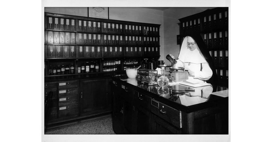 One of the Sister's of the Sorrowful Mother in the pharmacy filling prescriptions