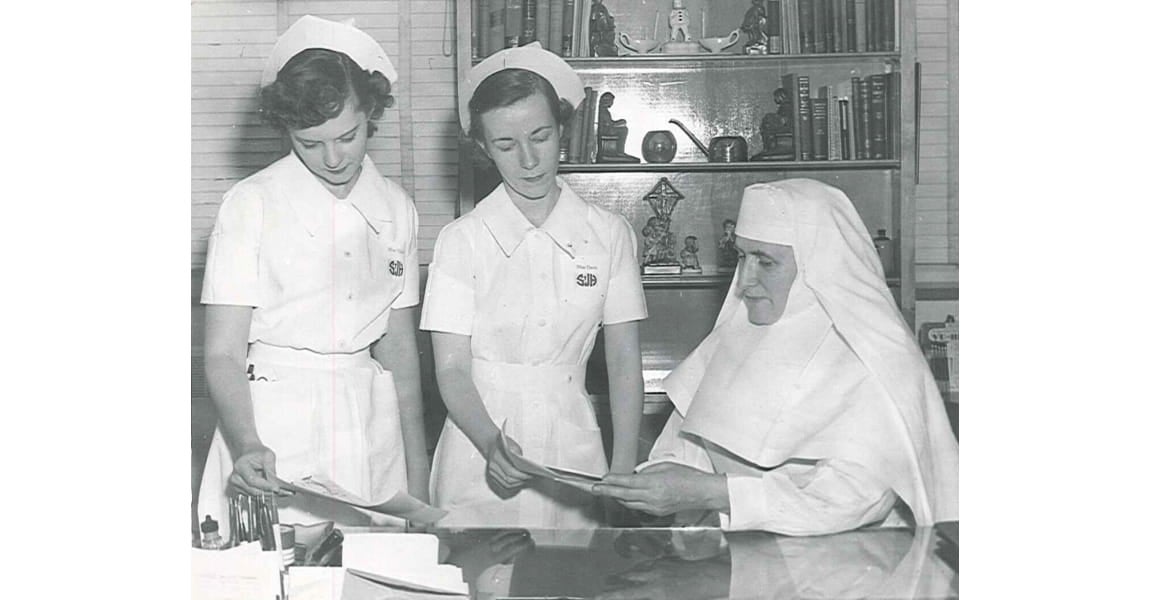 One of the Sister's of the Sorrowful Mother and alumni going over lesson