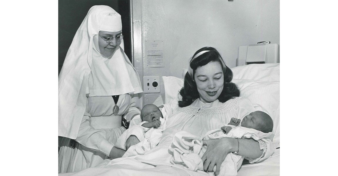 One of the Sister's of the Sorrowful Mother and visiting a patient who gave birth to twins