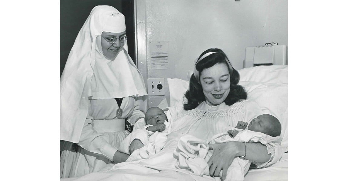 One of the Sister's of the Sorrowful Mother and visiting a patient who gave birth to twins