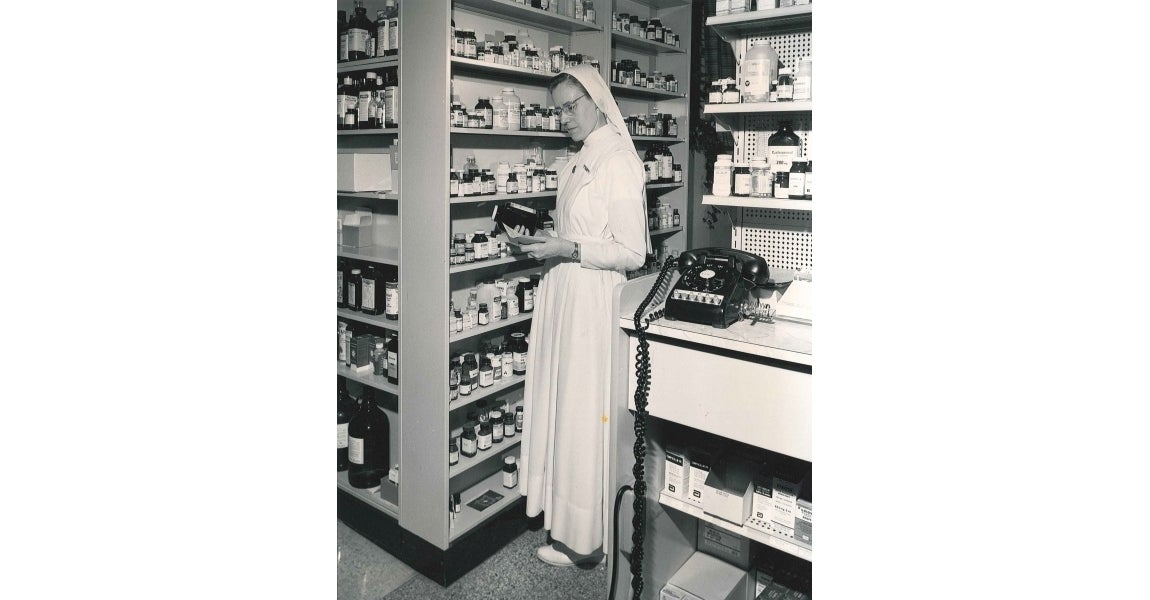 One of the Sister's of the Sorrowful Mother and alumni going over lesson