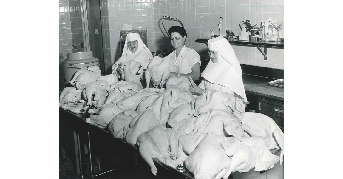 Two Sisters and a nurse preparing chicken in the kitchen of the St. John hospital in Tulsa, Oklahoma