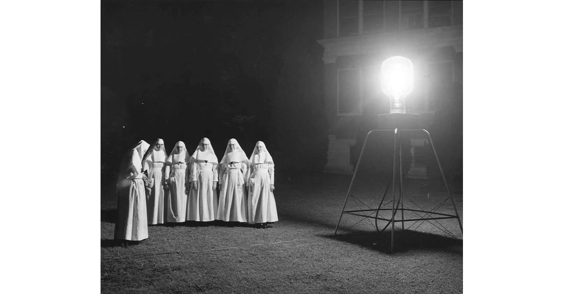 Sister's of the Sorrowful Mother taking picture at night of the St. John Medical Center in Tulsa, Oklahoma