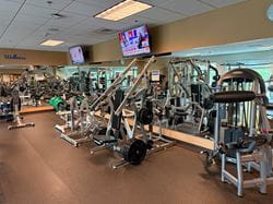 Strength training area at Ascension Saint Thomas Rutherford Wellness Center with resistance machines, weightlifting equipment, mirrors, and wellness-focused exercise spaces for rehabilitation and healthy living programs