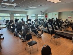 Cardio fitness room at Ascension Saint Thomas Rutherford Wellness Center with treadmills, recumbent bikes, ellipticals, and rehabilitation exercise equipment used for cardiac and pulmonary recovery programs.