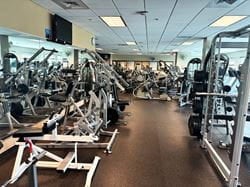 Open fitness floor at Ascension Saint Thomas Rutherford Wellness Center featuring resistance machines, weight racks, and cardio equipment for outpatient rehabilitation and personalized exercise programs.