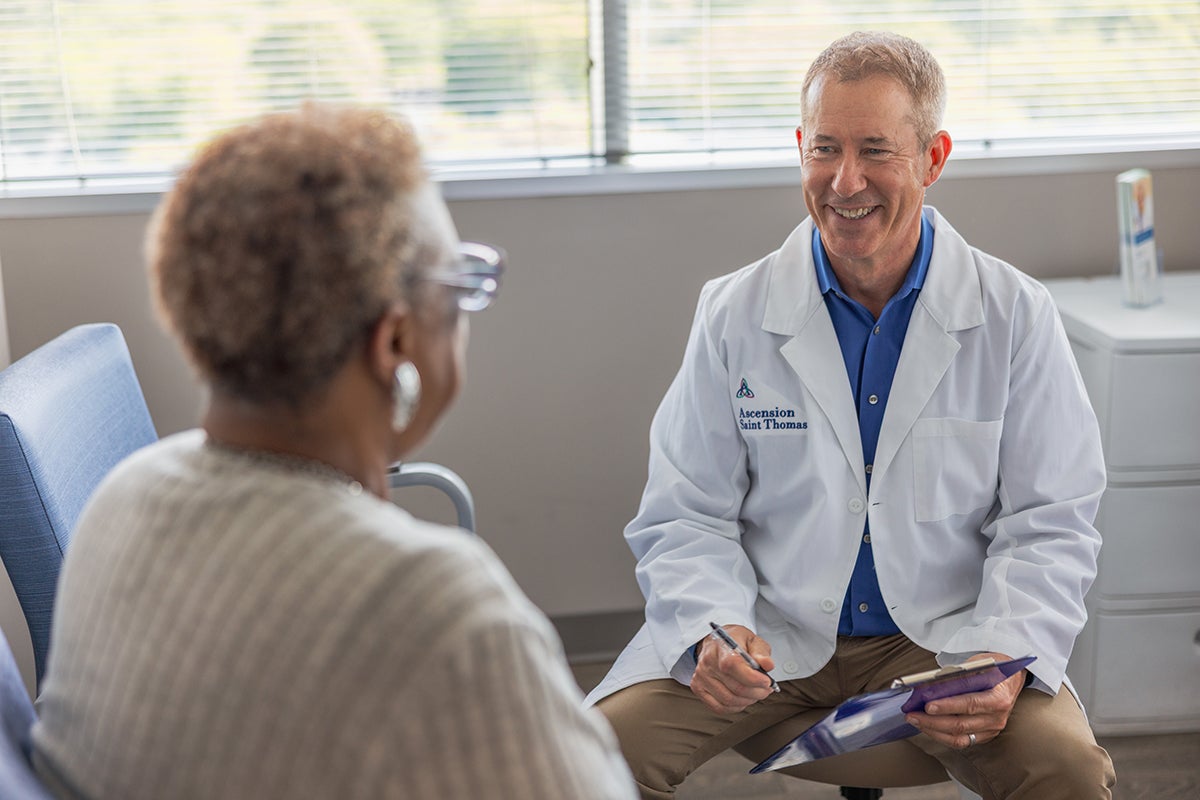 Dr. Douglas J. MacKenzie, a plastic surgeon at Ascension Saint Thomas in Murfressboro, TN,  speaks to a patient