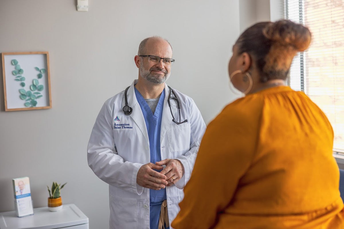 Mark Manwaring, MD talking with a patient