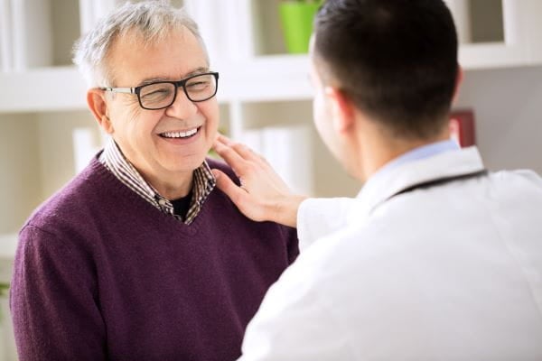 doctor talking to male patient