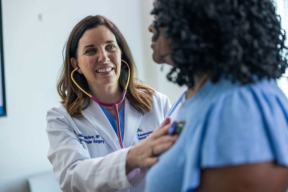 Hallie McNew, NP-C examining a patient