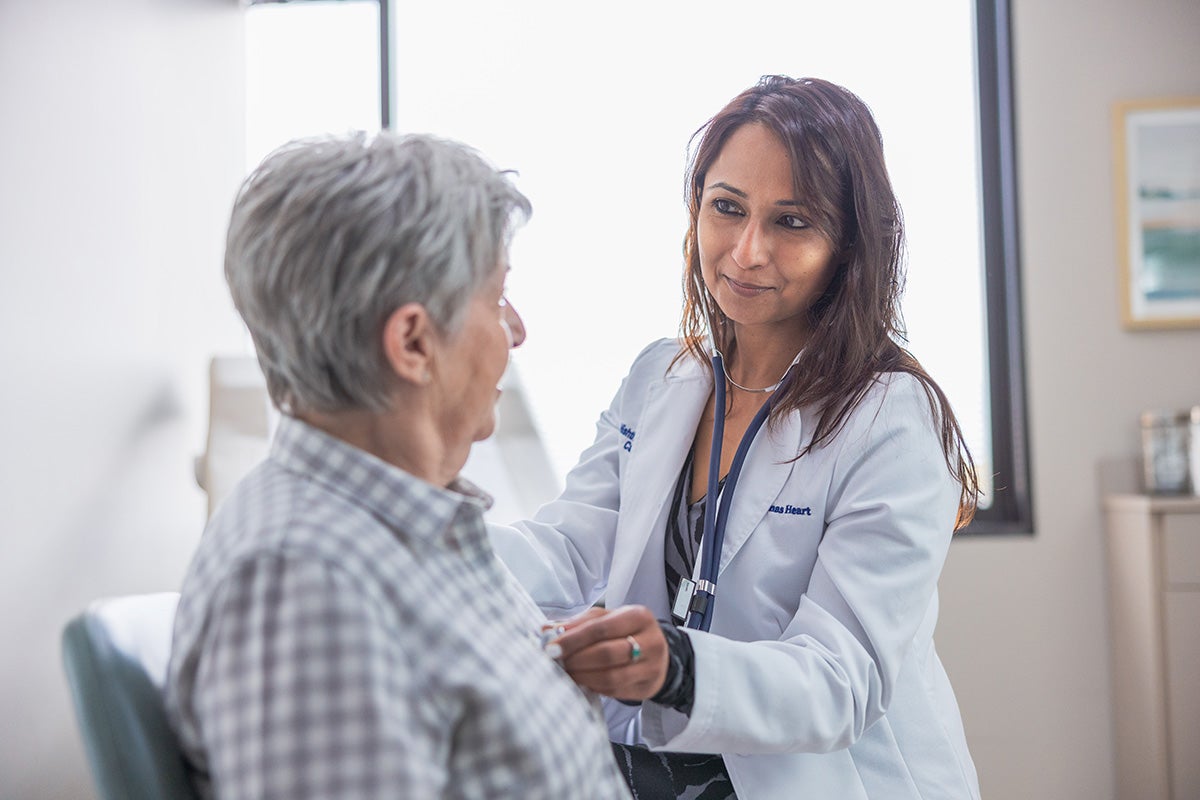 Nishtha Sareen, MD examining a patient