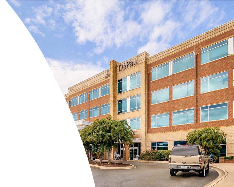 Exterior of Ascension Saint Thomas Premier Medicine Rutherford medical office building with brick facade, trees, and parking lot.