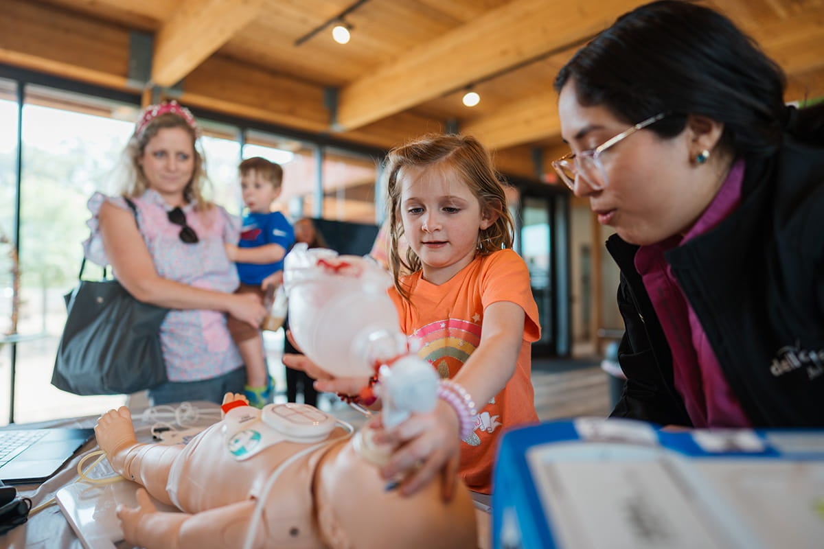 Girl learning CPR