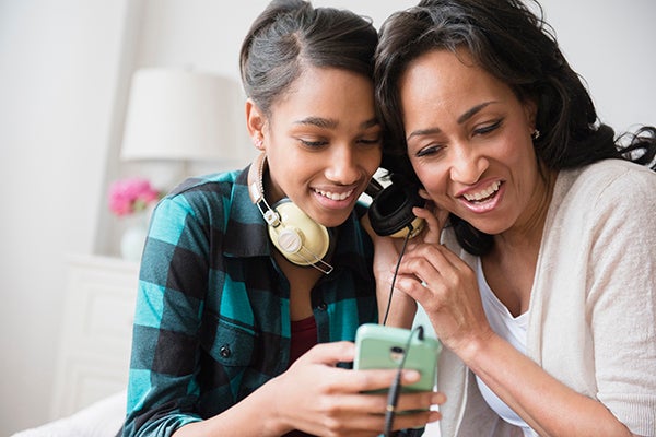 Teen black girl with mom listening to music