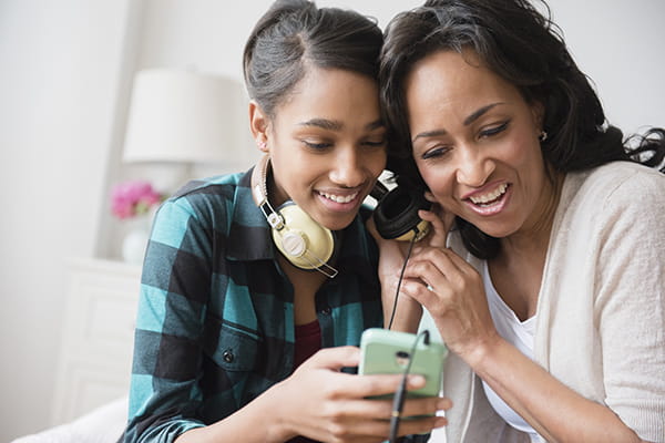 Teen black girl with mom listening to music