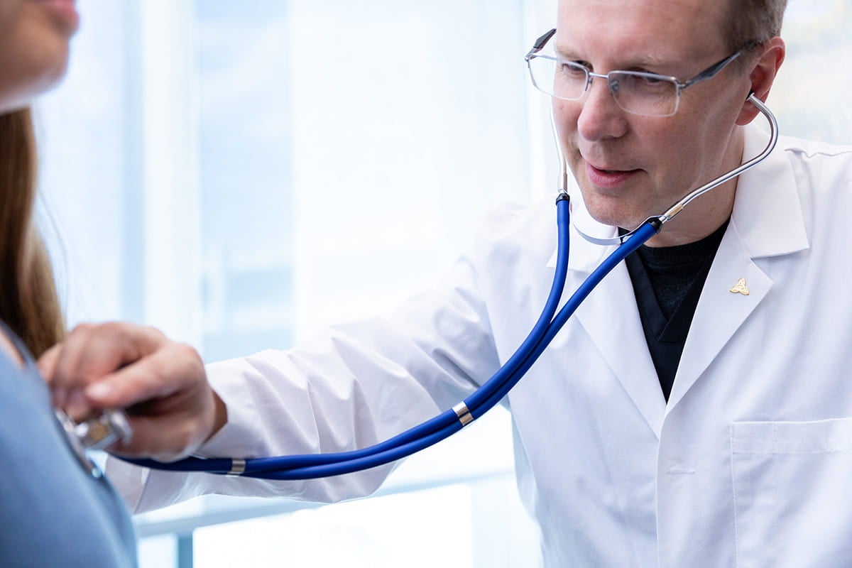 Juhana Karha, MD examining a patient