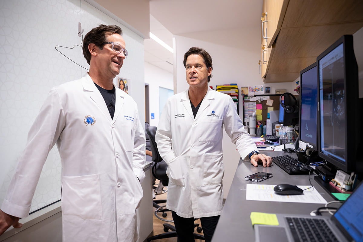 Spine care specialists review diagnostic imaging to develop coordinated surgical and non-surgical treatment plans.